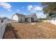 Spacious backyard featuring a white picket fence, a well-maintained lawn, and a covered patio at 509 Hillsborough Dr., Conway, SC 29526