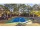 A community basketball court including a swing set, a picnic table, and mature trees at 509 Hillsborough Dr., Conway, SC 29526