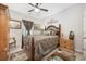 Comfortable bedroom with a ceiling fan, wood furnishings, decorative rug, and ornamental wall art at 509 Hillsborough Dr., Conway, SC 29526