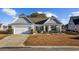 Charming single-story home with a well-maintained lawn, attached garage, and decorative shutters at 509 Hillsborough Dr., Conway, SC 29526