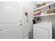 Functional laundry area with a white washer/dryer, shelves for storage, and a convenient door at 509 Hillsborough Dr., Conway, SC 29526