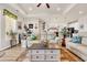 Bright living room with a ceiling fan, hardwood floors, and white couches with colorful accent pillows at 514 Hillsborough Dr., Conway, SC 29526