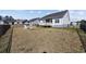 Large backyard with a deck, white Adirondack chairs, and wrought iron fence at 517 Antebellum Ln., Georgetown, SC 29440