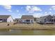 The back of the home features a porch and fenced-in backyard with a lake view at 517 Antebellum Ln., Georgetown, SC 29440