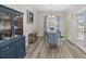 Inviting dining room with hardwood floors, a rustic table set, and natural light at 517 Antebellum Ln., Georgetown, SC 29440