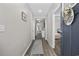 Bright hallway with wood-look floors leading to bedrooms and living areas, showcasing an open and airy floorplan at 517 Antebellum Ln., Georgetown, SC 29440