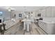 Open-concept kitchen with stainless steel appliances, quartz countertops, and a seamless flow to the living area at 517 Antebellum Ln., Georgetown, SC 29440