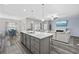 Bright, open-concept kitchen with modern island, pendant lights, stainless appliances, and seamless flow to living spaces at 517 Antebellum Ln., Georgetown, SC 29440
