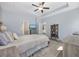 Spacious main bedroom featuring neutral colors, a tray ceiling, and ensuite access at 517 Antebellum Ln., Georgetown, SC 29440