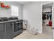 Well-equipped laundry room with modern washer and dryer and adjacent walk-in closet at 546 Calhoun Falls Dr., Myrtle Beach, SC 29577