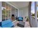 Screened in porch with contemporary furniture and a view to the inside living room through glass sliding doors at 5801 Oyster Catcher Dr. # 1623, North Myrtle Beach, SC 29582