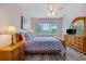 Cozy bedroom featuring a comfortable bed, wood floors, and ample closet space at 5801 Oyster Catcher Dr. # 1623, North Myrtle Beach, SC 29582