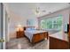Charming bedroom with wood floors, a comfortable bed, and natural light from the window at 5801 Oyster Catcher Dr. # 1623, North Myrtle Beach, SC 29582
