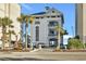Modern condo building with covered parking and lush landscaping on a sunny day at 5801 Oyster Catcher Dr. # 1623, North Myrtle Beach, SC 29582