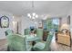 Bright dining area with wood floors, a glass table, comfortable chairs, and natural light at 5801 Oyster Catcher Dr. # 1623, North Myrtle Beach, SC 29582