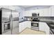 The kitchen features white cabinets, stainless steel appliances, and black countertops at 5801 Oyster Catcher Dr. # 1623, North Myrtle Beach, SC 29582