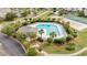 Aerial view of a community pool surrounded by lush landscaping and lounge chairs at 5801 Oyster Catcher Dr. # 1623, North Myrtle Beach, SC 29582