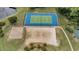 Aerial view of tennis and volleyball courts surrounded by trees and green space at 5801 Oyster Catcher Dr. # 1623, North Myrtle Beach, SC 29582
