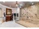Luxurious bathroom featuring a large walk-in shower with intricate tile work, and vanity with decorative mirror at 601 Tradewind Ct., North Myrtle Beach, SC 29582