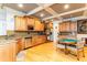 Large kitchen featuring stainless steel appliances, light wood cabinets, granite countertops, and a coffered ceiling at 601 Tradewind Ct., North Myrtle Beach, SC 29582