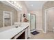 Neutral-toned bathroom features a walk-in shower, tile flooring, and a wide vanity with updated fixtures at 617 14Th Ave. S # 83, Surfside Beach, SC 29575