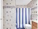 Bathroom with patterned wallpaper, shower and tub, and blue bathmat at 617 14Th Ave. S # 83, Surfside Beach, SC 29575