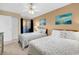 Bedroom with two beds, paintings, sliding glass door, and ceiling fan at 617 14Th Ave. S # 83, Surfside Beach, SC 29575