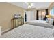 Bedroom with two beds, paintings, sliding glass door, TV, and ceiling fan at 617 14Th Ave. S # 83, Surfside Beach, SC 29575