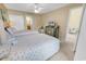 Bright bedroom featuring two beds, ceiling fan, and ensuite bathroom at 617 14Th Ave. S # 83, Surfside Beach, SC 29575