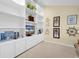 Well-lit office area with custom white built-in shelving, decorative accents, and warm beige walls with coastal artwork at 617 14Th Ave. S # 83, Surfside Beach, SC 29575