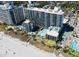 Stunning aerial view of the beachfront resort featuring pools, palm trees, and pristine sandy beach at 7200 Ocean Blvd. N # 1059, Myrtle Beach, SC 29572