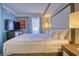 Serene bedroom featuring plush bedding, a TV, and sliding doors to a private balcony with views at 7200 Ocean Blvd. N # 1059, Myrtle Beach, SC 29572