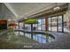 Bright indoor pool area with tables, chairs, and large windows offering exterior views of the resort at 7200 Ocean Blvd. N # 1059, Myrtle Beach, SC 29572
