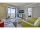 Living room with balcony access showcasing beautiful views, TV, and seating area to unwind and relax at 7200 Ocean Blvd. N # 1059, Myrtle Beach, SC 29572