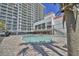 Outdoor pool area with lounge chairs and a building with oceanfront views at 7200 Ocean Blvd. N # 1059, Myrtle Beach, SC 29572