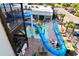 Aerial view of waterslides and kiddie pool area with lounge chairs and landscaping at 7200 Ocean Blvd. N # 1059, Myrtle Beach, SC 29572