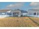 Backyard of the house featuring a fenced lawn, a screened patio, and solar panels on the roof at 852 Harrison Mill St., Myrtle Beach, SC 29579