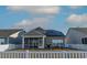 Backyard with a white picket fence and a screened patio, showcasing solar panels on the roof at 852 Harrison Mill St., Myrtle Beach, SC 29579