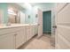 Bright bathroom with a double vanity, tile floor, and an open doorway to the toilet at 852 Harrison Mill St., Myrtle Beach, SC 29579