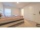 Cozy bedroom with carpet flooring, a window, and closet with a view into an ensuite bathroom at 852 Harrison Mill St., Myrtle Beach, SC 29579