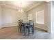 An empty dining room features wood floors, a tray ceiling, and bright natural light at 852 Harrison Mill St., Myrtle Beach, SC 29579