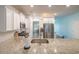 Spacious kitchen with granite countertops and stainless steel appliances overlooks the dining area at 852 Harrison Mill St., Myrtle Beach, SC 29579