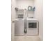 Bright laundry room featuring a white washer and dryer, tile floors, and a wire rack for storage at 852 Harrison Mill St., Myrtle Beach, SC 29579