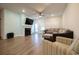 An open-concept living room has wood floors, a ceiling fan, and a cozy fireplace at 852 Harrison Mill St., Myrtle Beach, SC 29579