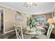 Inviting dining area with a glass table, complemented by an ocean view and a coastal aesthetic at 900 N Waccamaw Dr. # 301, Garden City Beach, SC 29576