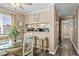 Dining area with a round glass table next to an open kitchen with stylish barstool seating at 900 N Waccamaw Dr. # 301, Garden City Beach, SC 29576