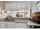Charming kitchen featuring modern appliances and a seamless connection to the living area with ocean views at 900 N Waccamaw Dr. # 301, Garden City Beach, SC 29576