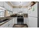 Functional kitchen with stainless steel appliances and white cabinetry, offering a seamless cooking experience at 900 N Waccamaw Dr. # 301, Garden City Beach, SC 29576