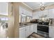 Well-equipped kitchen with sleek countertops and white cabinetry, offering a view of the ocean at 900 N Waccamaw Dr. # 301, Garden City Beach, SC 29576