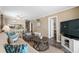 Inviting living room open to dining area, with sofa, chair, and TV at 900 N Waccamaw Dr. # 301, Garden City Beach, SC 29576